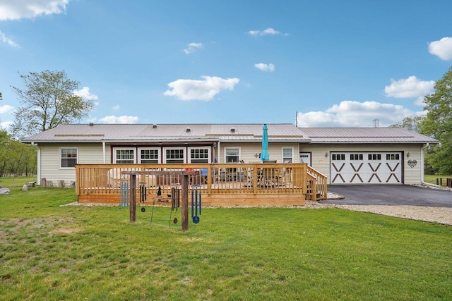 354 Pine Ct, Muscoda, WI 53573 - rear view of house featuring a deck, asphalt driveway, an attached garage, and a yard