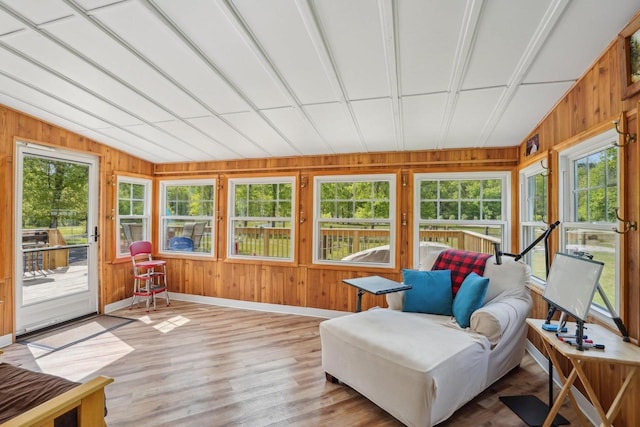354 Pine Ct, Muscoda, WI 53573 - sunroom / solarium featuring plenty of natural light, wood walls, baseboards, wood finished floors, and lofted ceiling