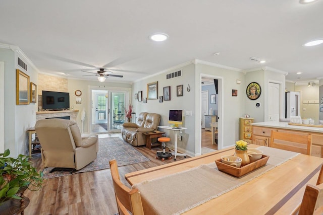 354 Pine Ct, Muscoda, WI 53573 - dining room with wood finished floors, ornamental molding, recessed lighting, ceiling fan, and baseboards