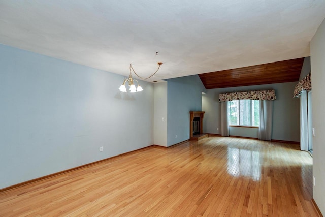 7423 Cedar Creek Trl, Madison, WI 53717 - unfurnished living room with a chandelier, light wood-type flooring, baseboards, and a fireplace with raised hearth