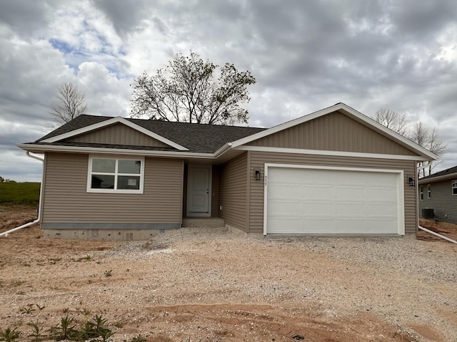959 Sully Way, Sheboygan Falls, WI 53085 - ranch-style home with dirt driveway, a garage, a shingled roof, and central AC unit