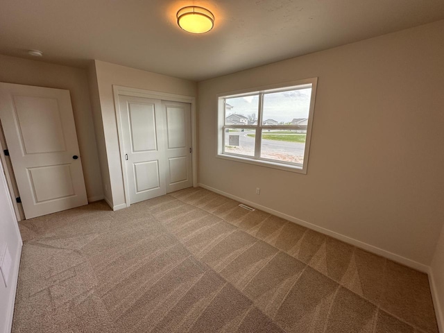 959 Sully Way, Sheboygan Falls, WI 53085 - unfurnished bedroom with light carpet, a closet, and baseboards