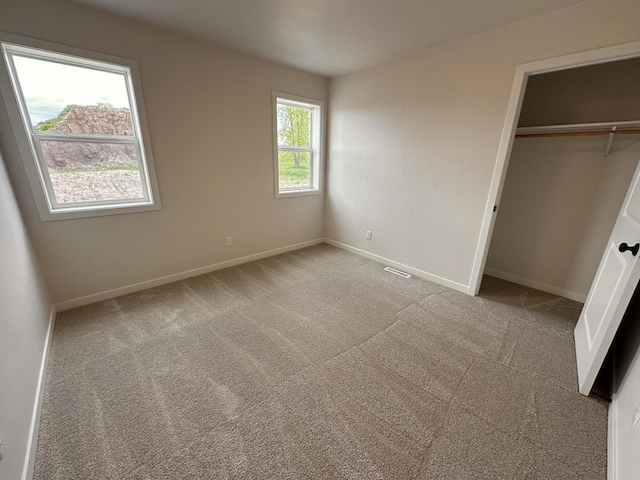 959 Sully Way, Sheboygan Falls, WI 53085 - unfurnished bedroom featuring light carpet, baseboards, and a closet