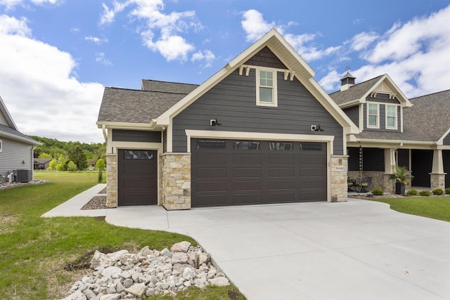 W4949 Cottage Ln, Sherwood, WI 54169 - craftsman-style home featuring stone siding, driveway, an attached garage, a front yard, and cooling unit