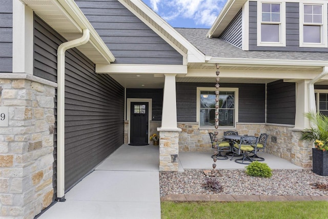 W4949 Cottage Ln, Sherwood, WI 54169 - entrance to property featuring a porch, stone siding, and roof with shingles