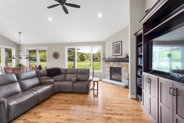 W4949 Cottage Ln, Sherwood, WI 54169 - living room featuring lofted ceiling, a stone fireplace, a ceiling fan, recessed lighting, and light wood-style floors