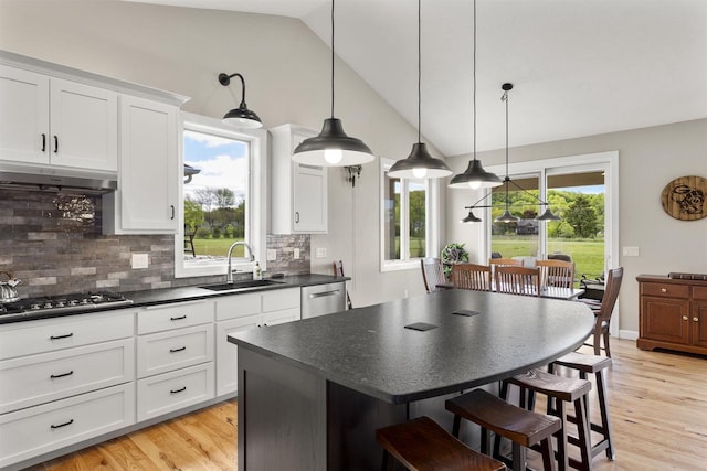 W4949 Cottage Ln, Sherwood, WI 54169 - kitchen featuring a sink, dark countertops, stainless steel appliances, backsplash, and lofted ceiling