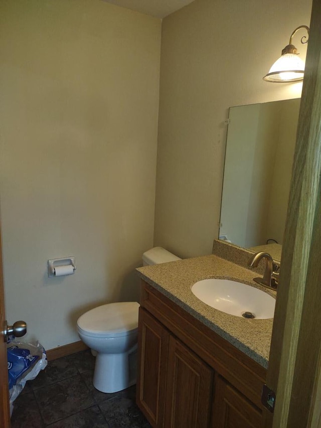 1041 Sundown Ct, Mukwonago, WI 53149 - bathroom featuring toilet, vanity, tile patterned flooring, and baseboards