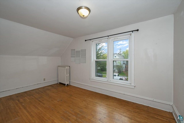 1112 Baxter Ave, Superior, WI 54880 - bonus room with radiator, hardwood / wood-style flooring, lofted ceiling, and baseboards