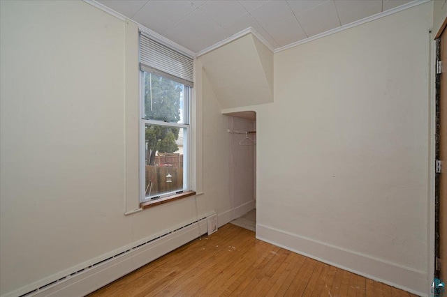 1112 Baxter Ave, Superior, WI 54880 - unfurnished room with a baseboard heating unit, ornamental molding, light wood-style flooring, and baseboards