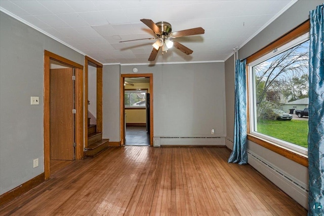 1112 Baxter Ave, Superior, WI 54880 - empty room with baseboard heating, crown molding, ceiling fan, and light wood-style floors
