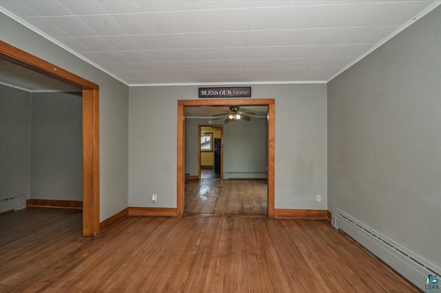 1112 Baxter Ave, Superior, WI 54880 - unfurnished room featuring baseboard heating, ornamental molding, a baseboard radiator, hardwood / wood-style floors, and baseboards