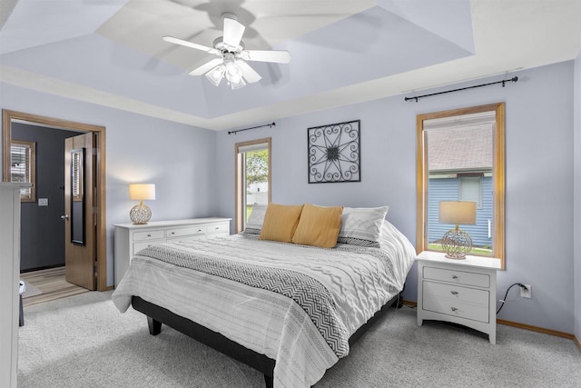 W5841 Easter Lily Dr, Appleton, WI 54915 - bedroom with light carpet, baseboards, a ceiling fan, and a raised ceiling