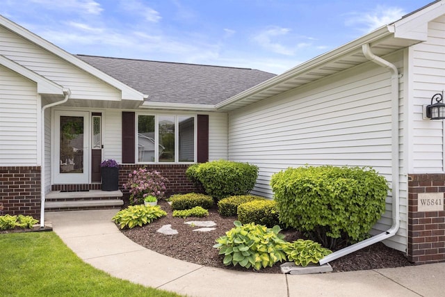 W5841 Easter Lily Dr, Appleton, WI 54915 - entrance to property featuring roof with shingles and brick siding