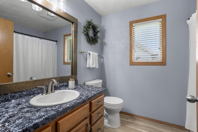 W5841 Easter Lily Dr, Appleton, WI 54915 - bathroom with toilet, wood finished floors, vanity, baseboards, and curtained shower
