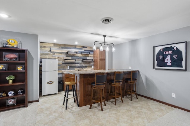 W5841 Easter Lily Dr, Appleton, WI 54915 - indoor wet bar with freestanding refrigerator, recessed lighting, baseboards, and hanging light fixtures