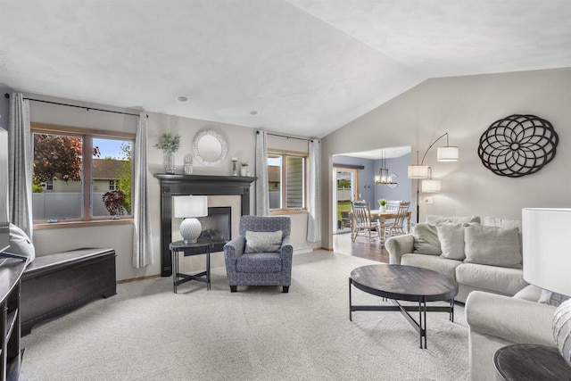 W5841 Easter Lily Dr, Appleton, WI 54915 - living area with carpet flooring, vaulted ceiling, a fireplace, a chandelier, and baseboards