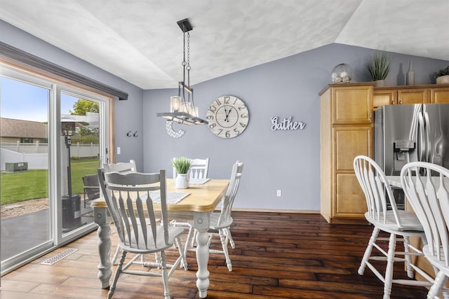 W5841 Easter Lily Dr, Appleton, WI 54915 - dining room featuring vaulted ceiling, wood finished floors, a chandelier, and baseboards