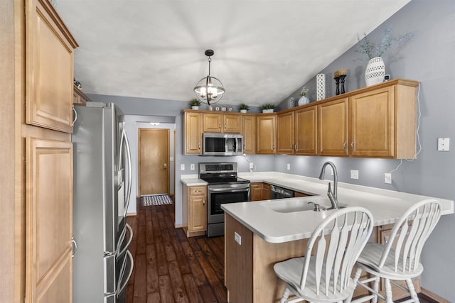 W5841 Easter Lily Dr, Appleton, WI 54915 - kitchen with stainless steel appliances, a peninsula, light countertops, a breakfast bar, and dark wood-type flooring