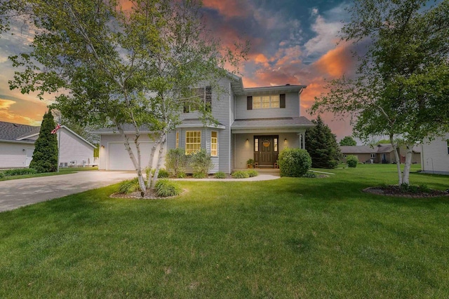 665 N Prairie Rd, Fond Du Lac, WI 54935 - traditional-style home with concrete driveway, a lawn, and an attached garage