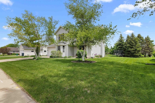 665 N Prairie Rd, Fond Du Lac, WI 54935 - view of property hidden behind natural elements featuring a trampoline, driveway, a front yard, and an attached garage