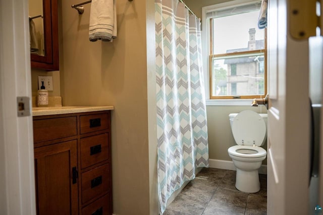 1223 Macarthur Ave, Ashland, WI 54806 - bathroom with toilet, vanity, baseboards, and a shower with shower curtain