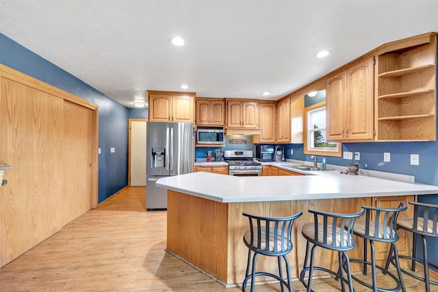 3687 Foxwoods Ln, Abrams, WI 54101 - kitchen featuring appliances with stainless steel finishes, a sink, a peninsula, light countertops, and recessed lighting