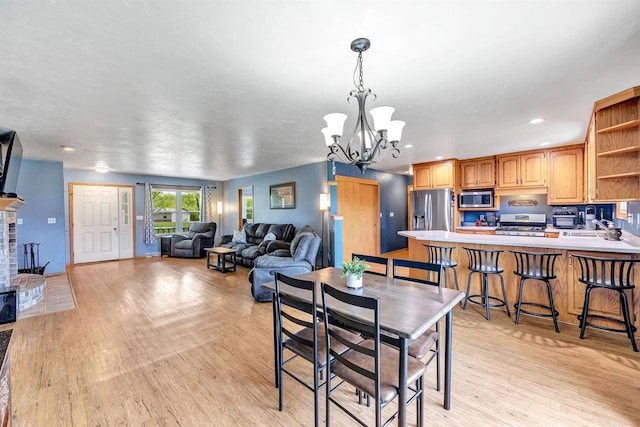 3687 Foxwoods Ln, Abrams, WI 54101 - dining space featuring light wood-type flooring, a chandelier, recessed lighting, and a fireplace