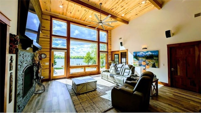 N528 Park Dr, New Auburn, WI 54757 - living area featuring wood ceiling with exposed beams, high vaulted ceiling, wood-type flooring, ceiling fan, and a stone fireplace