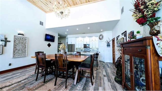 N528 Park Dr, New Auburn, WI 54757 - dining area with a towering ceiling, dark wood-style floors, a chandelier, and baseboards