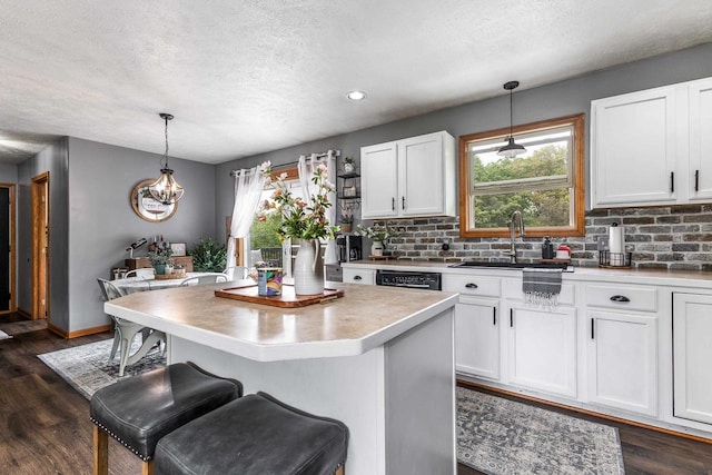 1320 Raymond Ct, Platteville, WI 53818 - kitchen with a sink, a textured ceiling, backsplash, white cabinetry, and recessed lighting
