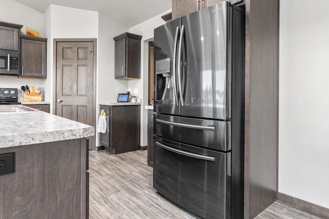 1732 Patriot Way, Neenah, WI 54956 - kitchen with stainless steel appliances, dark brown cabinets, light countertops, light wood-style flooring, and baseboards