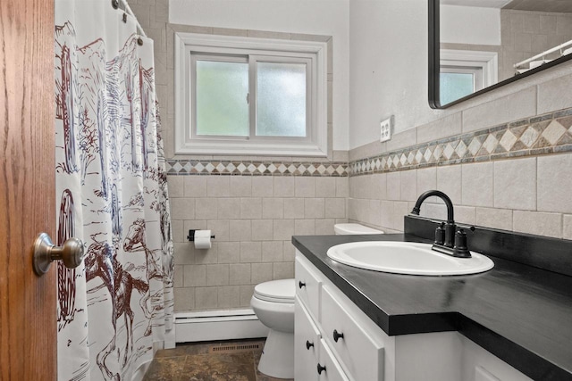 1651 4th St, Port Edwards, WI 54469 - bathroom with baseboard heating, vanity, toilet, curtained shower, and tile walls