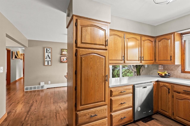 1651 4th St, Port Edwards, WI 54469 - kitchen featuring stainless steel dishwasher, dark wood-type flooring, light countertops, baseboards, and backsplash