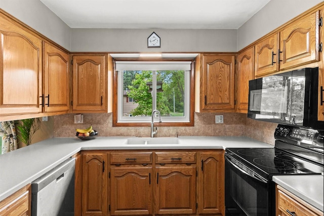 1651 4th St, Port Edwards, WI 54469 - kitchen featuring black appliances, a sink, light countertops, and backsplash
