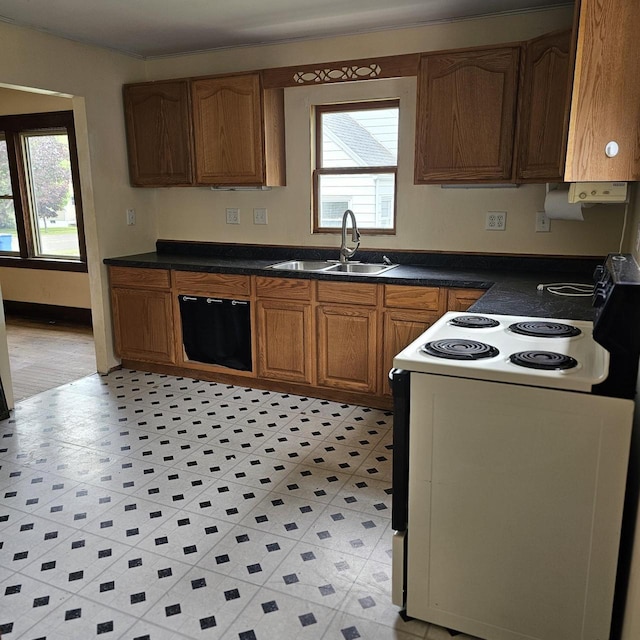 1048 W Wisconsin St, Portage, WI 53901 - kitchen featuring electric stove, a sink, dark countertops, brown cabinets, and dishwashing machine