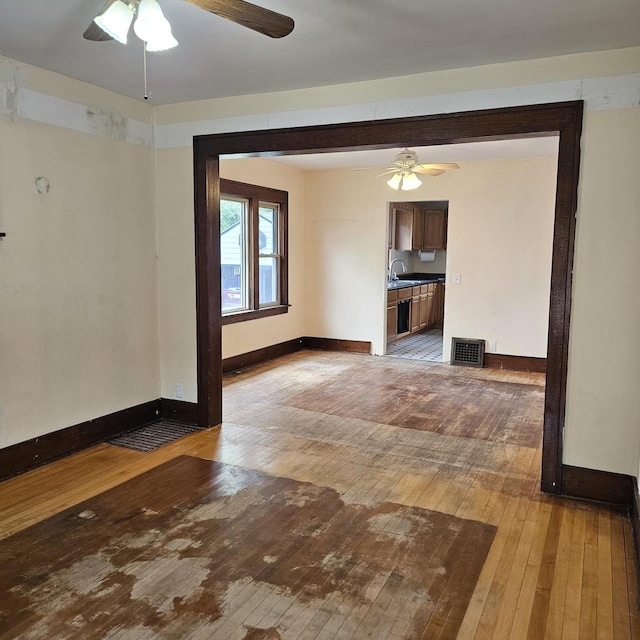 1048 W Wisconsin St, Portage, WI 53901 - unfurnished living room with a ceiling fan, light wood-type flooring, and baseboards
