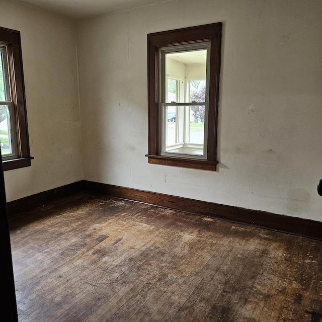1048 W Wisconsin St, Portage, WI 53901 - empty room featuring dark wood-type flooring and baseboards