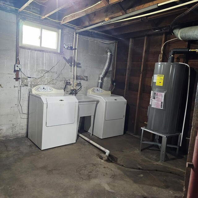 1048 W Wisconsin St, Portage, WI 53901 - below grade area with electric water heater, washer and clothes dryer, and a sink