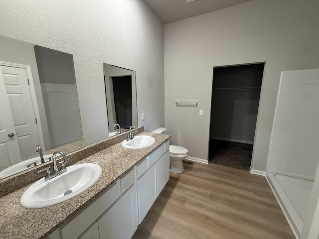 941 Colt Dr, Belleville, WI 53508 - full bath with wood finished floors, double vanity, toilet, and a spacious closet