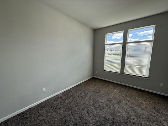 941 Colt Dr, Belleville, WI 53508 - spare room featuring baseboards and dark colored carpet