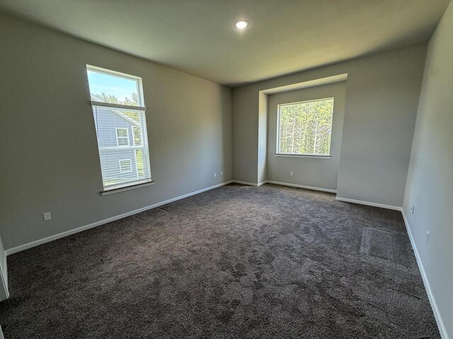 941 Colt Dr, Belleville, WI 53508 - unfurnished room featuring dark carpet, baseboards, and recessed lighting