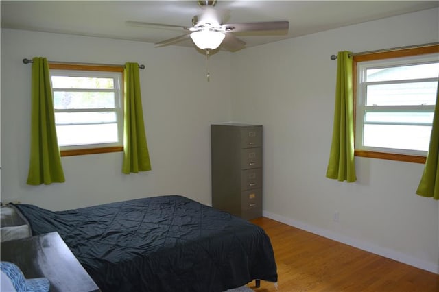 1905 E Clairemont Ave, Eau Claire, WI 54701 - bedroom with multiple windows, wood finished floors, baseboards, and a ceiling fan