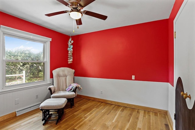 4705 Winnequah Rd, Monona, WI 53716 - living area with a baseboard radiator, wood finished floors, baseboards, and ceiling fan