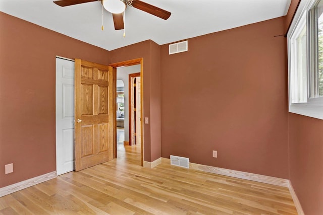 4705 Winnequah Rd, Monona, WI 53716 - unfurnished bedroom with baseboards, light wood-style flooring, and a ceiling fan