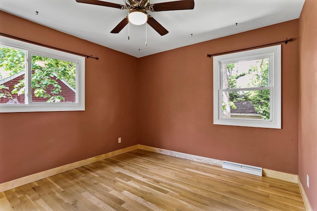 4705 Winnequah Rd, Monona, WI 53716 - unfurnished room with healthy amount of natural light, baseboards, light wood-style flooring, and ceiling fan