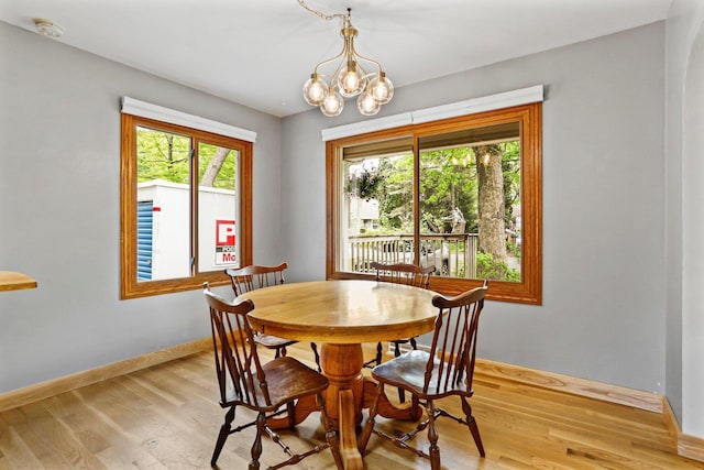4705 Winnequah Rd, Monona, WI 53716 - dining room featuring plenty of natural light, light wood finished floors, baseboards, and a chandelier