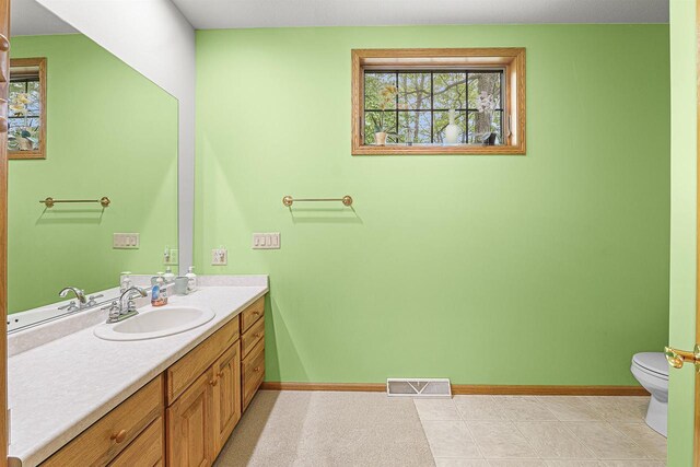 705 Red Fox, Fond Du Lac, WI 54937 - bathroom featuring toilet, vanity, and baseboards