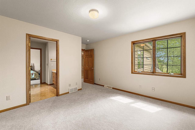 705 Red Fox, Fond Du Lac, WI 54937 - unfurnished bedroom featuring light carpet, baseboards, and ensuite bathroom