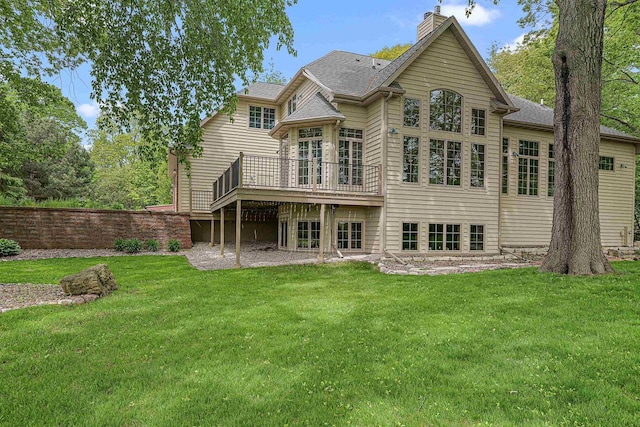 705 Red Fox, Fond Du Lac, WI 54937 - rear view of house featuring a deck, a lawn, a chimney, and roof with shingles